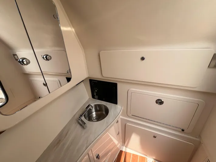  Yacht Photos Pics 2020 Grady-White Freedom 335 boat interior with sink and storage cabinets.