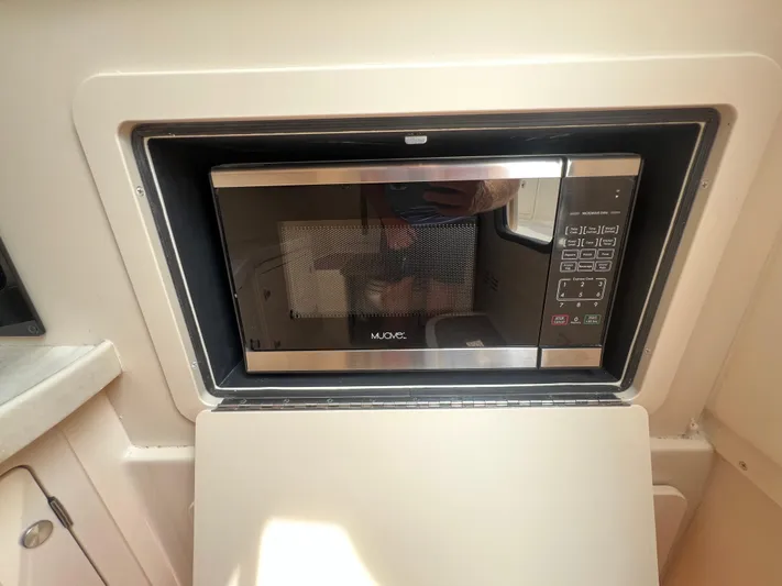  Yacht Photos Pics Built-in microwave in 2020 Grady-White Freedom 335 boat interior.