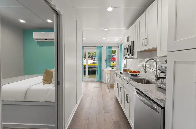  Yacht Photos Pics Modern kitchen and bedroom interior of Hank's 40 Houseboat, 2025 model, featuring sleek design.