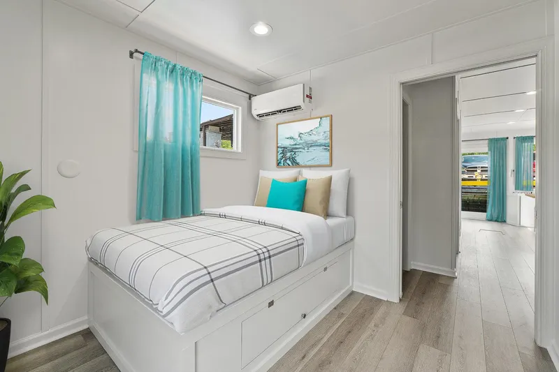  Yacht Photos Pics Modern interior of Hank's 40 Houseboat, 2025, featuring a cozy bedroom with teal accents.