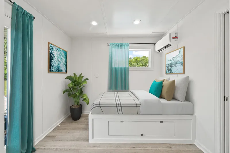  Yacht Photos Pics Modern houseboat bedroom with teal accents, plant, and wall art.