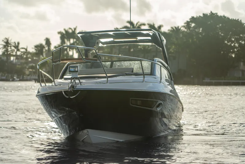  Yacht Photos Pics 2024 Hanover 305 boat on water, front view, with trees in the background.