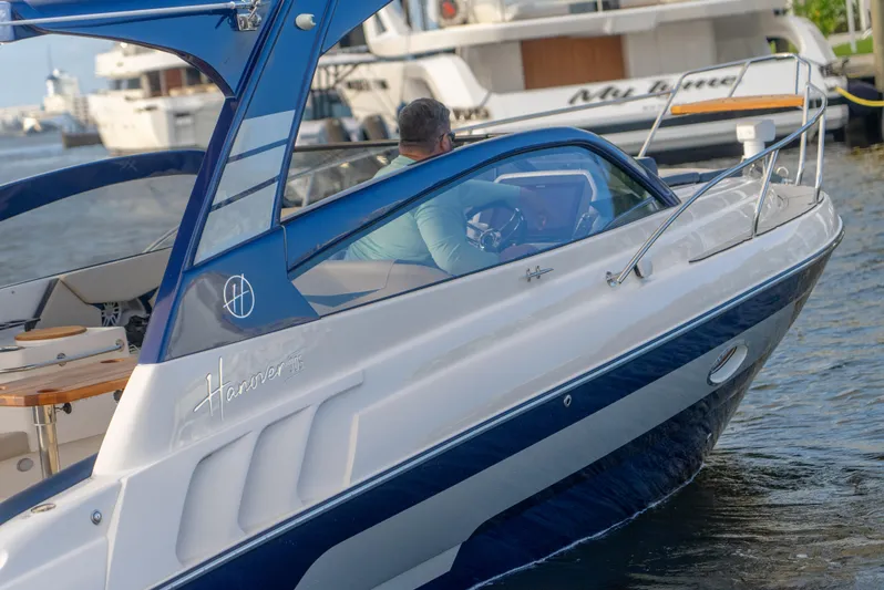  Yacht Photos Pics 2024 Hanover 305 boat cruising on water, featuring sleek design and modern amenities.
