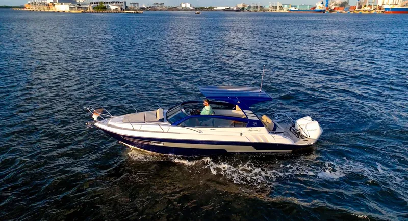  Yacht Photos Pics 2024 Hanover 305 boat cruising on open water, featuring sleek design and modern amenities.