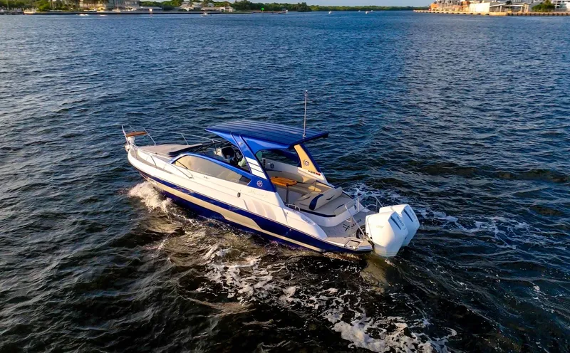  Yacht Photos Pics 2024 Hanover 305 boat cruising on open water, showcasing sleek design and powerful engine.