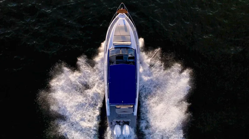  Yacht Photos Pics Aerial view of 2024 Hanover 305 boat cruising on water, creating dynamic wake patterns.