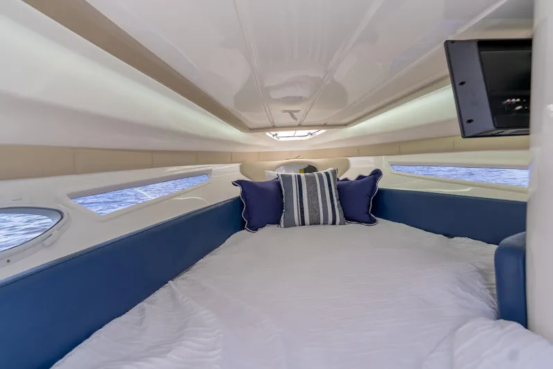  Yacht Photos Pics Interior cabin of 2024 Hanover 305 boat with cozy bedding and pillows.