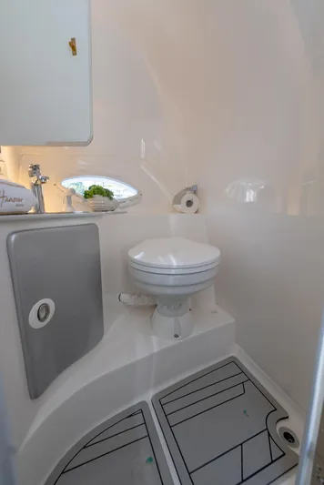  Yacht Photos Pics Compact bathroom in 2024 Hanover 305 model, featuring modern fixtures and sleek design.