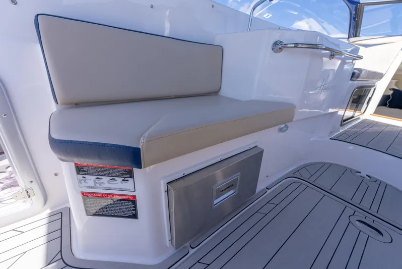  Yacht Photos Pics 2024 Hanover 305 boat interior with cushioned seating and storage compartment.