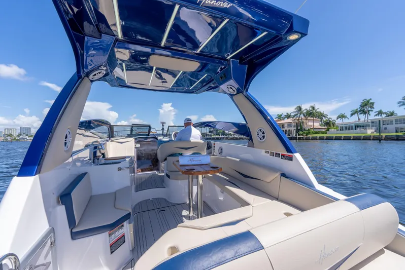  Yacht Photos Pics 2024 Hanover 305 boat interior with luxurious seating and table on a sunny day.