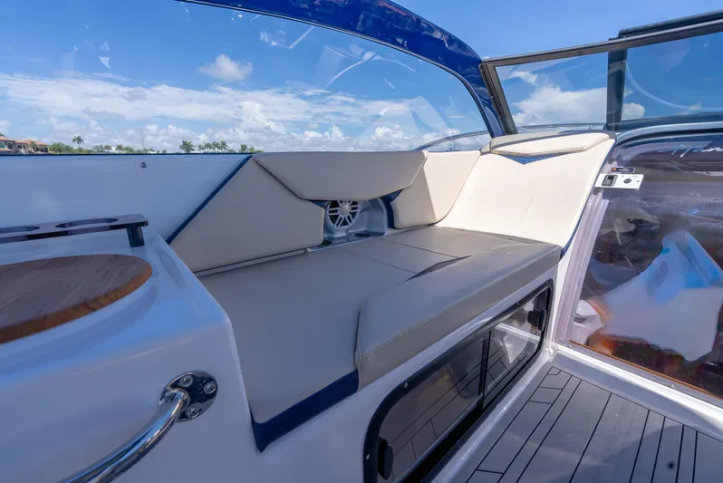  Yacht Photos Pics 2024 Hanover 305 boat interior with cushioned seating and sleek design.