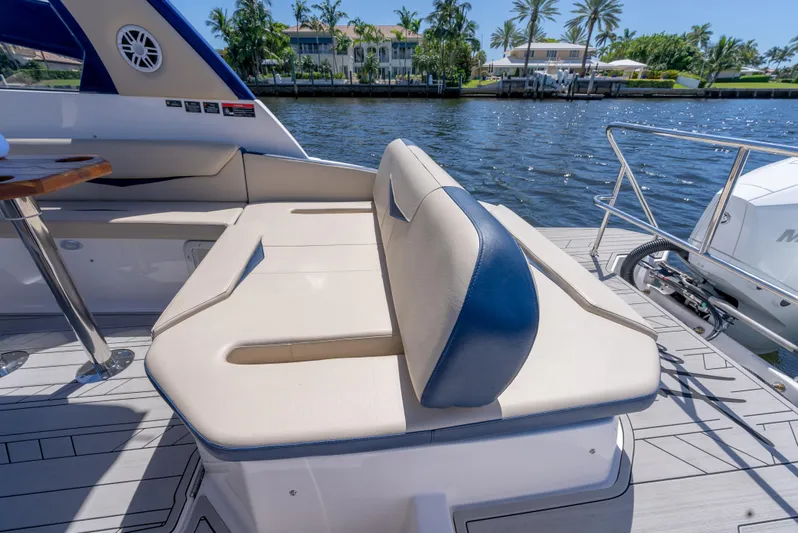  Yacht Photos Pics Luxurious seating on a 2024 Hanover 305 yacht, docked by a scenic waterfront.