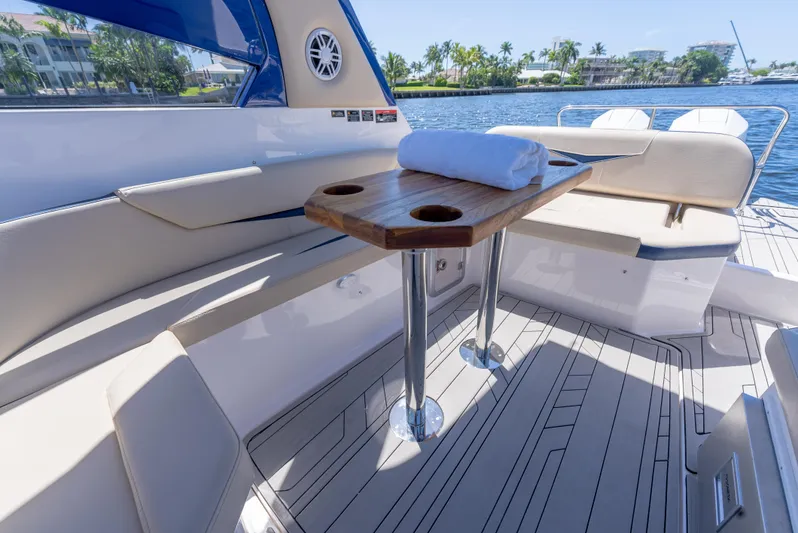 Yacht Photos Pics Luxurious 2024 Hanover 305 yacht interior with elegant seating and wooden table.