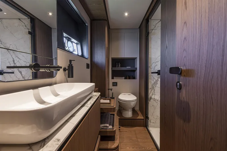  Yacht Photos Pics Luxurious bathroom interior of 2025 Ferretti Yachts 580, featuring modern fixtures and elegant wood finishes.