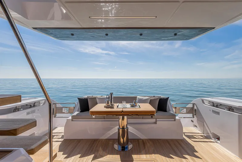  Yacht Photos Pics Luxurious 2025 Ferretti Yachts 580 deck with ocean view and elegant seating area.