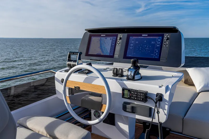  Yacht Photos Pics Helm of 2025 Ferretti Yachts 580 with dual navigation screens, steering wheel, and ocean view.