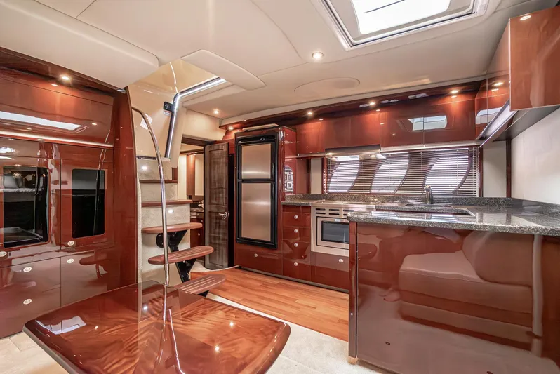  Yacht Photos Pics Luxurious interior of 2007 Sea Ray 48 Sundancer yacht with modern kitchen and wooden finishes.