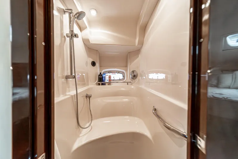  Yacht Photos Pics Shower area in 2007 Sea Ray 48 Sundancer yacht, featuring modern fixtures and porthole window.