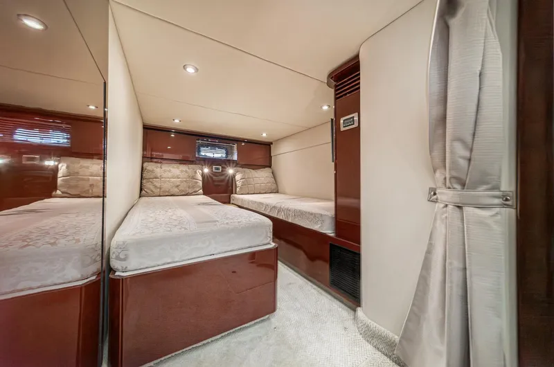  Yacht Photos Pics 2007 Sea Ray 48 Sundancer cabin with twin beds, elegant wood finish, and soft lighting.