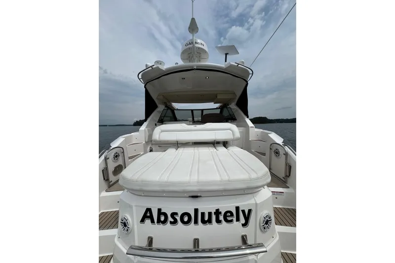 Absolutely Yacht Photos Pics 2017 Regal 42 Sport Coupe yacht with "Absolutely" on the stern, docked on a calm day.