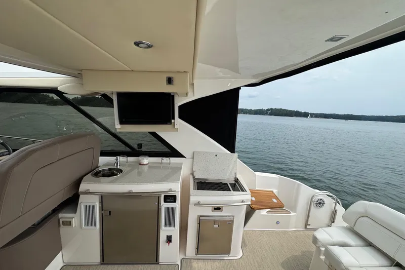 Absolutely Yacht Photos Pics 2017 Regal 42 Sport Coupe yacht interior with kitchenette and lake view.