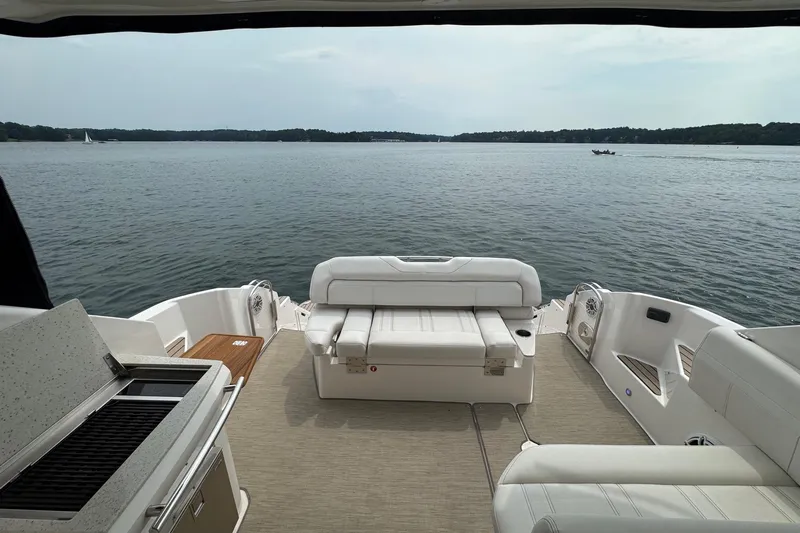 Absolutely Yacht Photos Pics 2017 Regal 42 Sport Coupe yacht interior with lake view, featuring seating and grill.