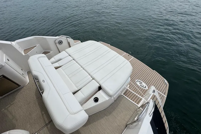 Absolutely Yacht Photos Pics 2017 Regal 42 Sport Coupe boat with luxurious seating on a wooden deck.