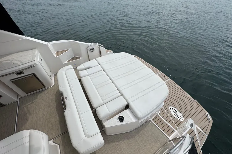 Absolutely Yacht Photos Pics 2017 Regal 42 Sport Coupe boat with white seating and teak deck by the water.