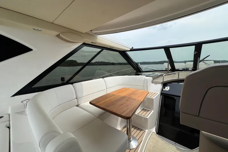 Absolutely Yacht Photos Pics Luxurious interior of 2017 Regal 42 Sport Coupe yacht with elegant seating and wooden table.