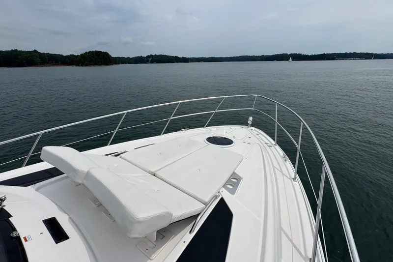 Absolutely Yacht Photos Pics 2017 Regal 42 Sport Coupe yacht on calm waters with sunbathing deck.