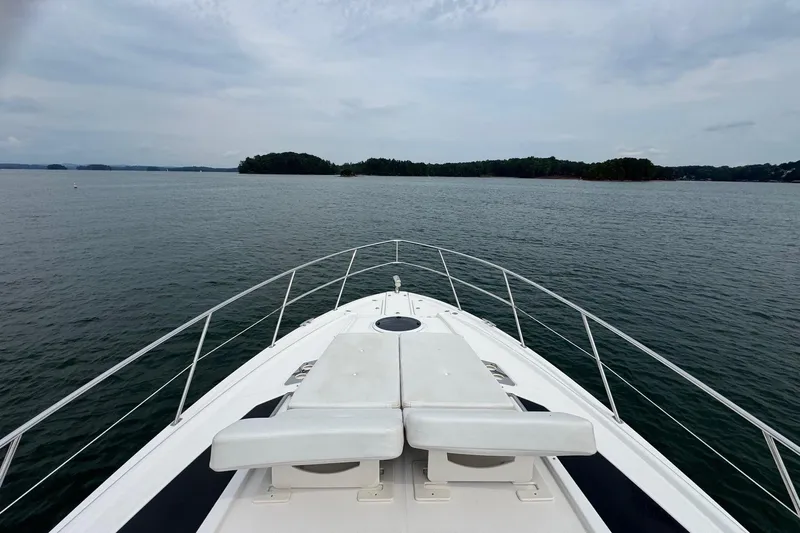 Absolutely Yacht Photos Pics Bow view of 2017 Regal 42 Sport Coupe on a serene lake.