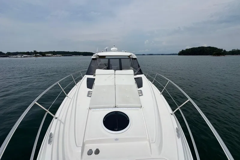Absolutely Yacht Photos Pics 2017 Regal 42 Sport Coupe yacht cruising on a calm lake.