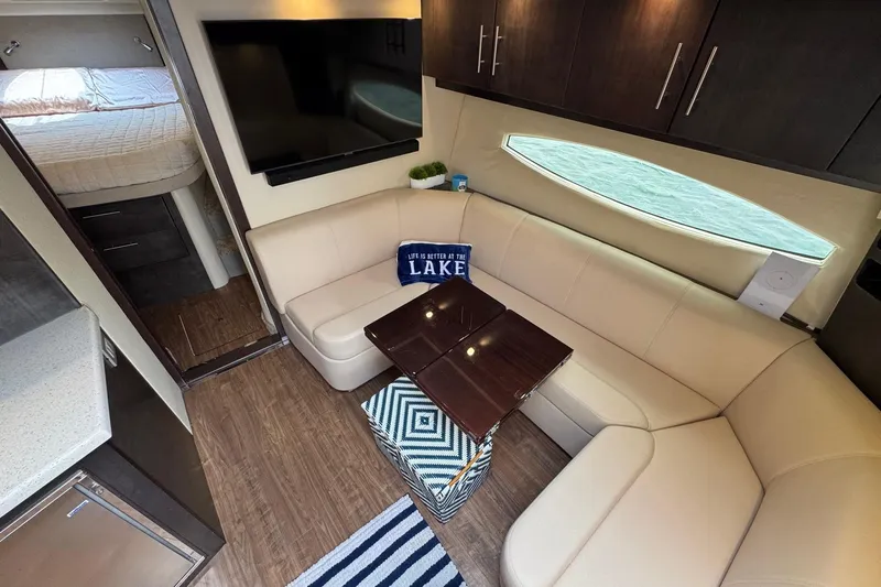 Absolutely Yacht Photos Pics Luxurious interior of 2017 Regal 42 Sport Coupe with beige seating and modern decor.