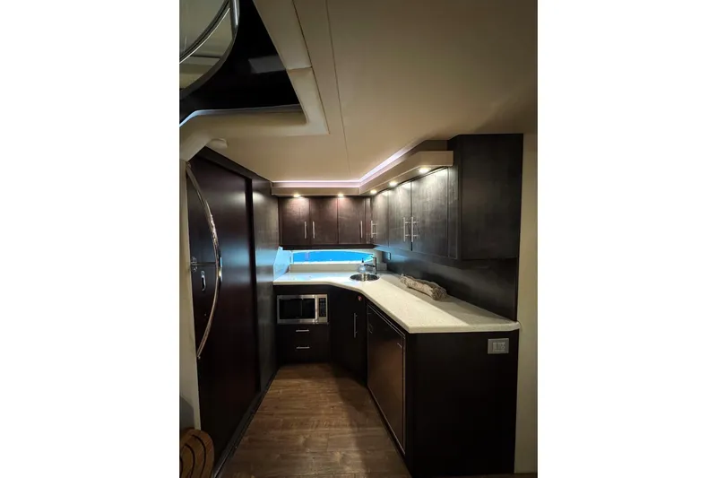 Absolutely Yacht Photos Pics Luxurious interior of 2017 Regal 42 Sport Coupe yacht kitchen with modern cabinetry.