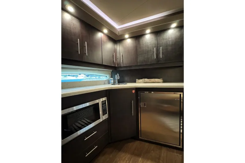 Absolutely Yacht Photos Pics Luxurious kitchen interior of 2017 Regal 42 Sport Coupe yacht with modern appliances.