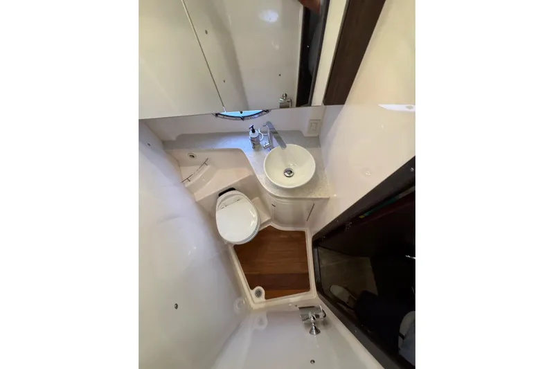 Absolutely Yacht Photos Pics Bathroom interior of 2017 Regal 42 Sport Coupe yacht, featuring sink and toilet.