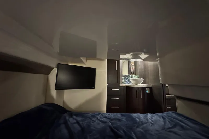 Absolutely Yacht Photos Pics Interior of 2017 Regal 42 Sport Coupe with bed, TV, and modern cabinetry.