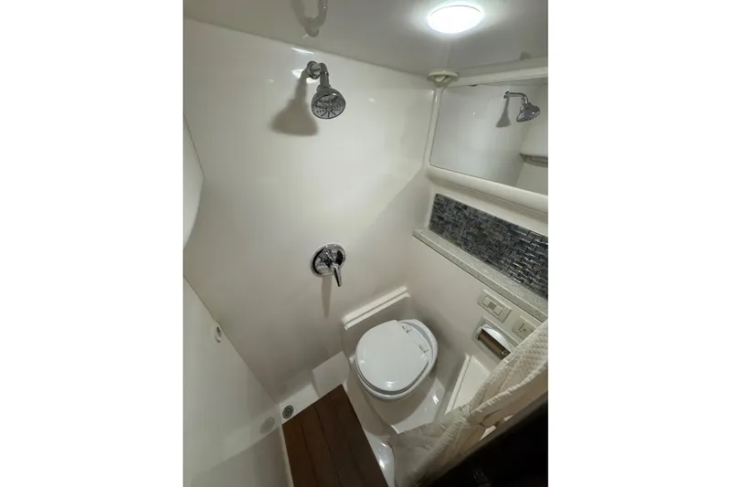 Absolutely Yacht Photos Pics Bathroom interior of 2017 Regal 42 Sport Coupe yacht, featuring modern fixtures and sleek design.