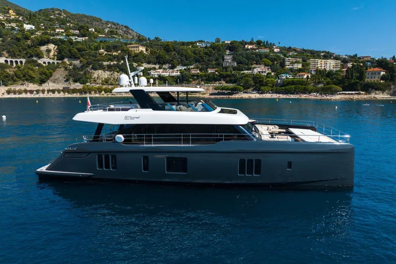 Manta Yacht Photos Pics Luxurious 2022 Sunreef 80 Power MANTA yacht cruising near scenic coastline.