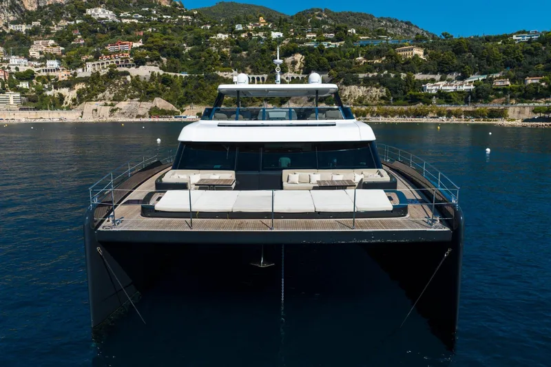 Manta Yacht Photos Pics Luxury Sunreef 80 Power MANTA yacht, 2022 model, docked near scenic coastline.