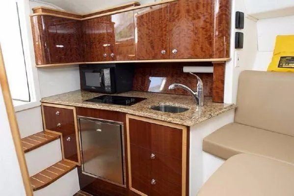 Maripal Yacht Photos Pics Luxurious 2008 Contender 38 Express yacht kitchen with wood cabinets and granite countertops.