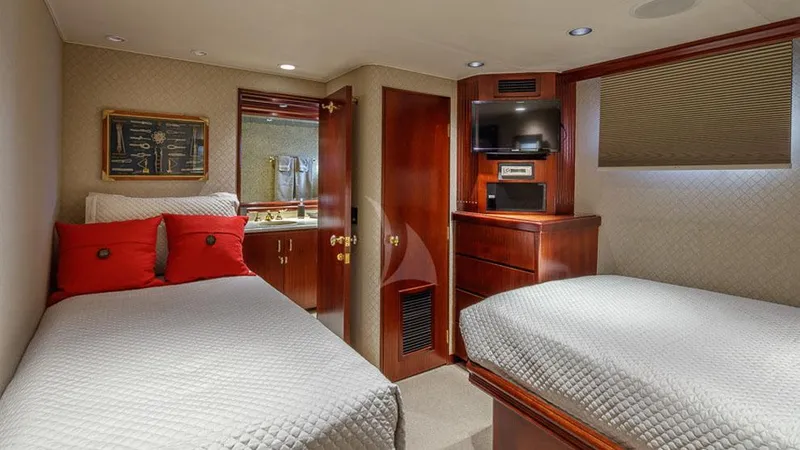 Blackwood Yacht Photos Pics Luxurious cabin interior of 1998 Broward 103 yacht with twin beds and elegant wood finishes.