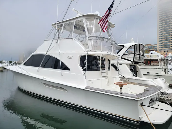  Yacht Photos Pics 2001 Ocean Yachts 56 Super Sport docked at marina, featuring flybridge and American flag.