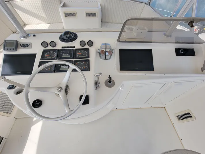  Yacht Photos Pics 2001 Ocean Yachts 56 Super Sport helm station with steering wheel and navigation instruments.