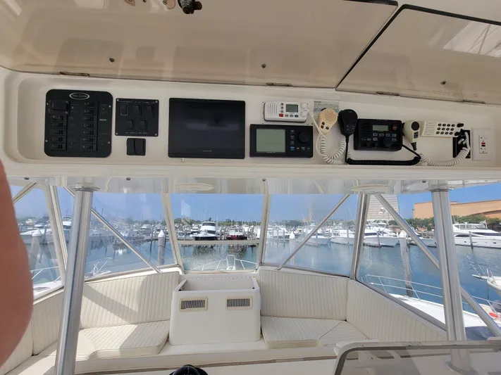  Yacht Photos Pics 2001 Ocean Yachts 56 Super Sport helm with navigation equipment and marina view.