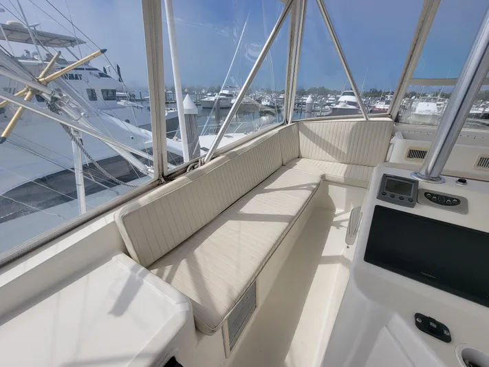  Yacht Photos Pics 2001 Ocean Yachts 56 Super Sport flybridge seating area with marina view.