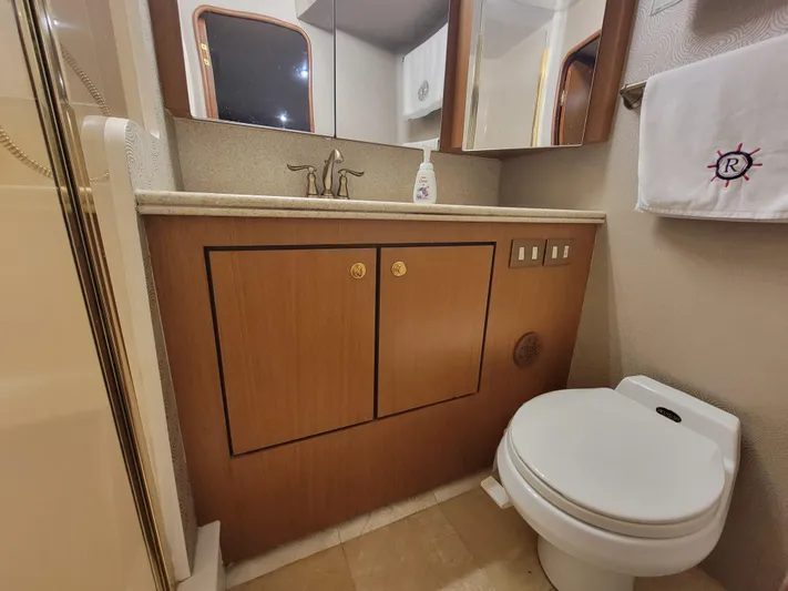  Yacht Photos Pics Bathroom of a 2001 Ocean Yachts 56 Super Sport with wooden cabinets and modern fixtures.