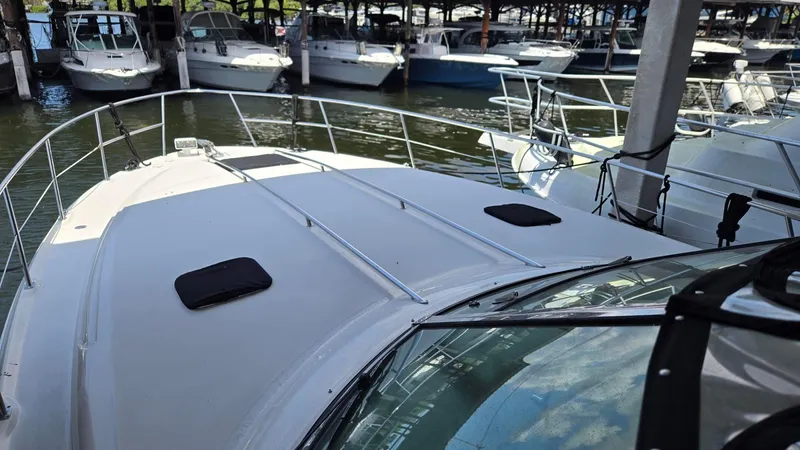 One More Time Yacht Photos Pics 2004 Sea Ray 380 Sundancer docked among other boats in a marina.