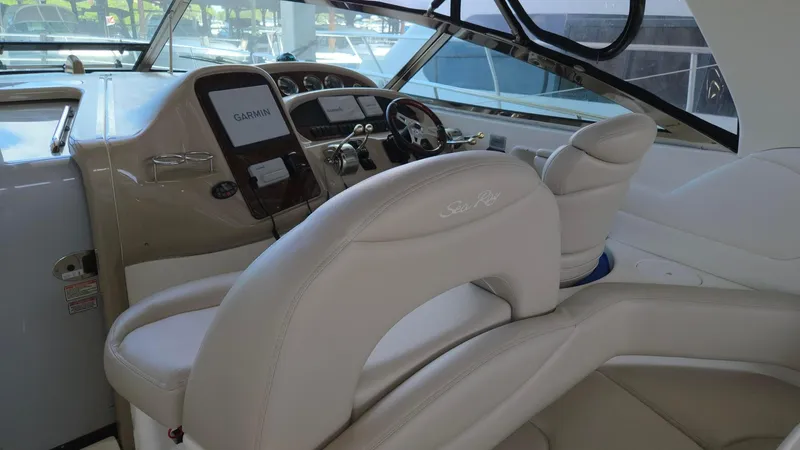 One More Time Yacht Photos Pics 2004 Sea Ray 380 Sundancer helm with leather seating and modern controls.