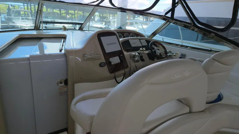 One More Time Yacht Photos Pics 2004 Sea Ray 380 Sundancer helm with steering wheel and navigation equipment.